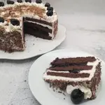Bake Oma’s Black Forest Cake (Schwarzwälder Kirschtorte) with rich chocolate, cherries, whipped cream, and a splash of Kirsch.