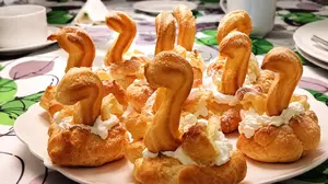 Oma's easy cream puff recipe makes an impressive German dessert, Windbeutel. Filled with whipped cream, topped with chocolate and even made into swans or a magnificent cake. Lecker!