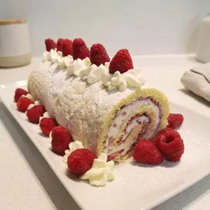 Oma's Cream Roll recipe, Biskuitrolle, is the German version of a Swiss roll or jelly roll. Filled with whipped cream and studded with berries, this is an easy-to-make treat anytime of the year.