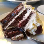 Easiest German Black Forest Cherry Cake you'll ever make. Chocolate cake, cherries, and light and fluffy, real whipped cream! LECKER SCHMECKER!