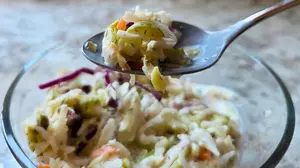 Dill pickle coleslaw served with German pork chops and potato salad