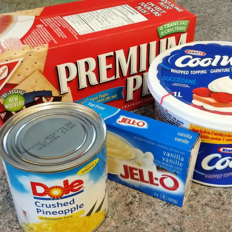 Unsalted soda crackers, instant vanilla pudding mix, Cool Whip, and canned crushed pineapple.