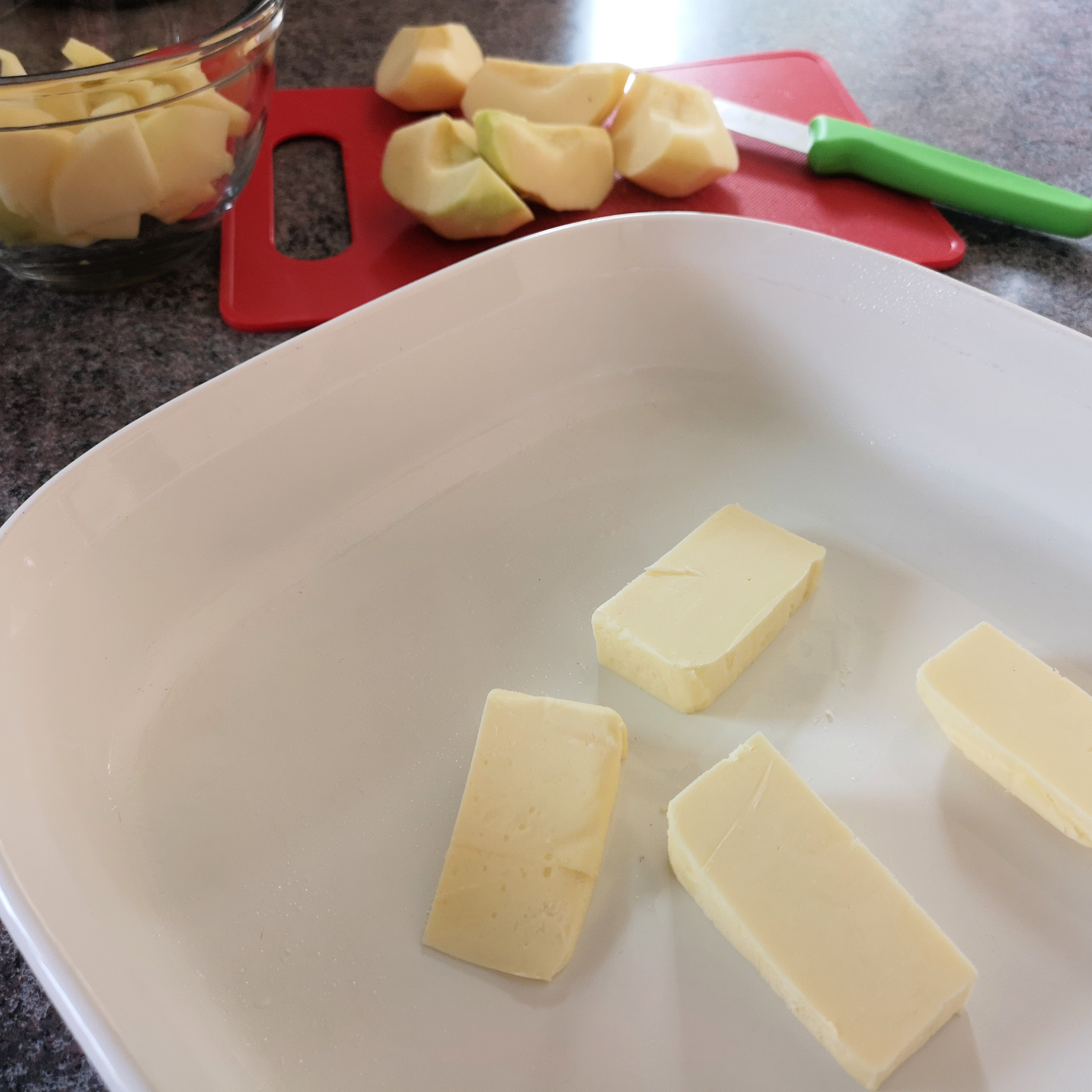 Put butter in pan and into the preheated oven