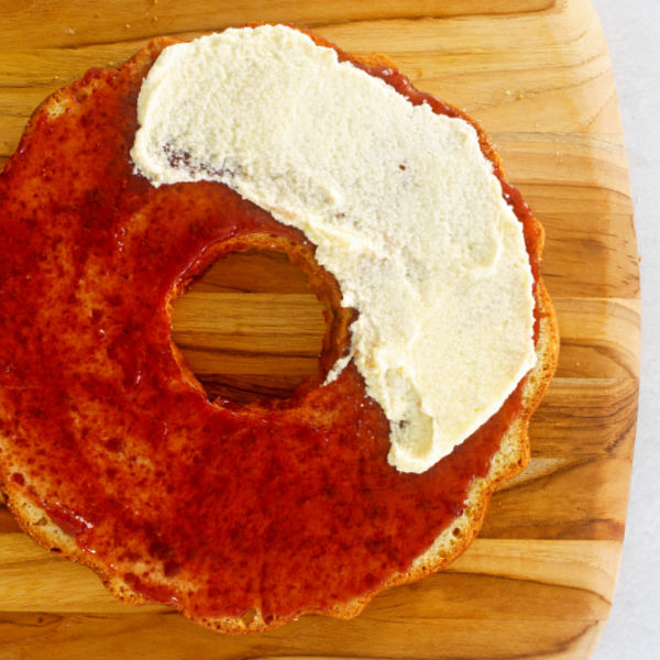 Spread jam over bottom layer and cover with buttercream
