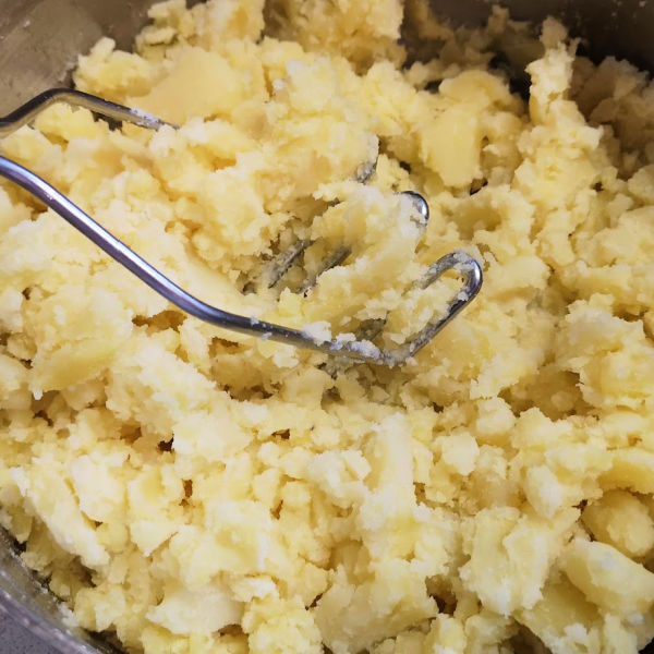 Mash potatoes with a potato masher Mash potatoes with a potato masher