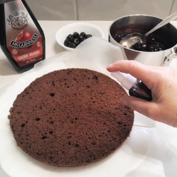 Spray each cake layer with cherry brandy Spray each cake layer with cherry brandy
