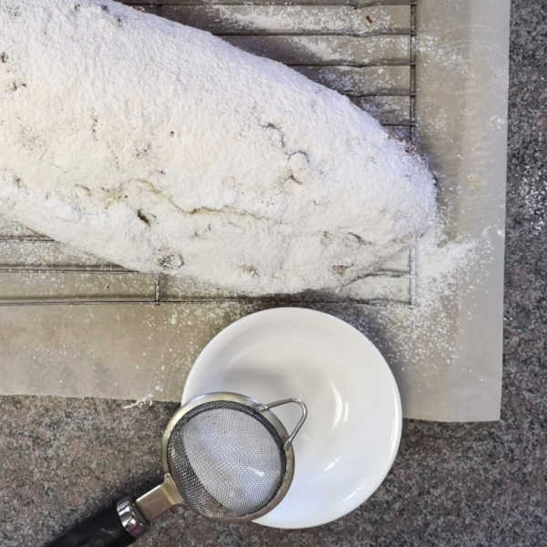 Dust warm stollen with powdered sugar Dust warm stollen with powdered sugar