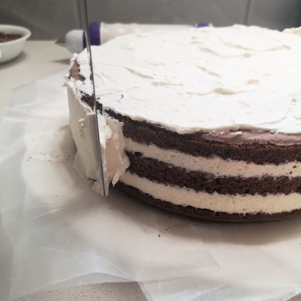 Skim coat the outside of the Black Forest Cake Skim coat the outside of the Black Forest Cake