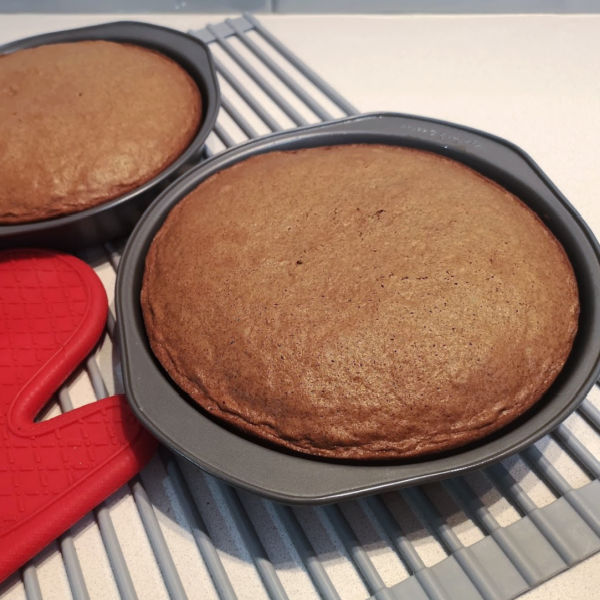 The two layers of the chocolate cake are cooling