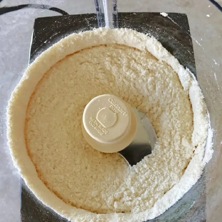 Almond flour and powdered sugar blended together in a food processor