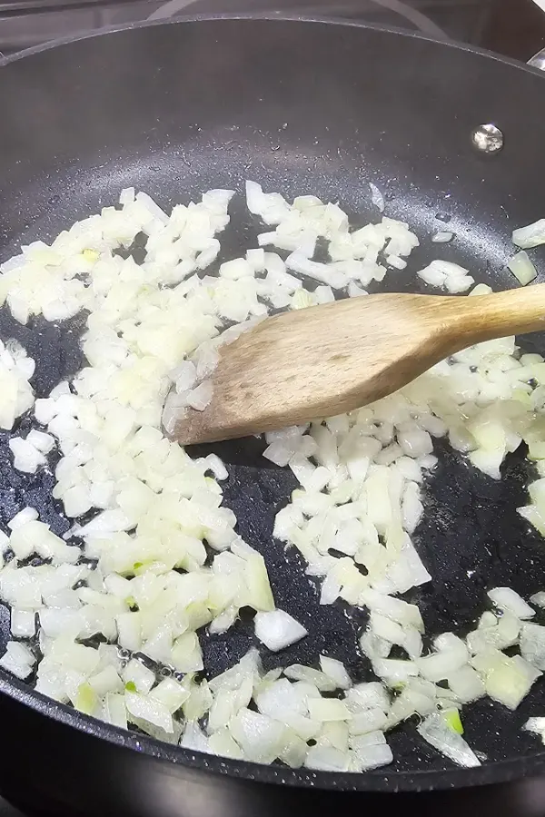 Chopped onion softening in olive oil and butter in a skillet