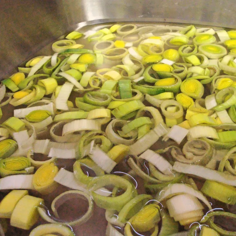 Rinsing Leeks Thoroughly Sliced leeks soaking in water to remove dirt and grit