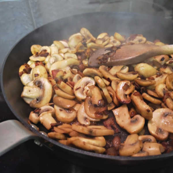 Once the mushrooms are cooked, they're ready for the tomato paste and liquid to be added