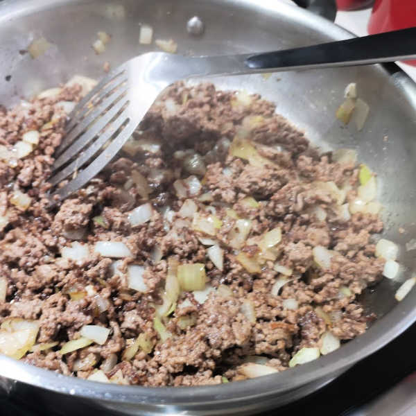 Continue browning the meat and add onions for this lazy cabbage roll recipe until browned. Continue browning the meat and add onions for this lazy cabbage roll recipe until browned.