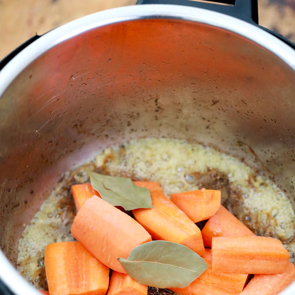Saute onions and carrots and add bay leaves