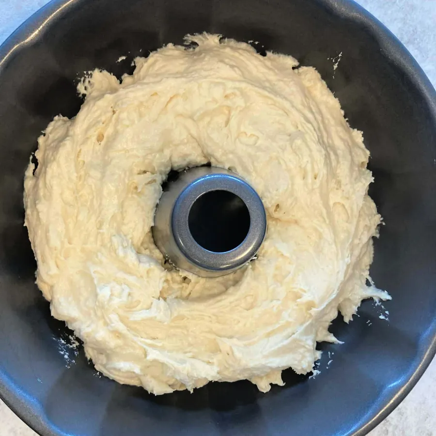 Vanilla batter spread in a greased Bundt pan for vegan German marble cake
