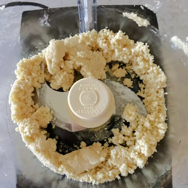 Crumbly homemade marzipan mixture in a food processor