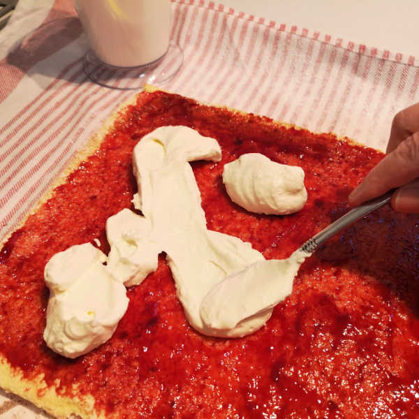 Spreading the jam and cream. Don't be afraid to get crafty with these when you make them, you can fill them with any fruit you desire!