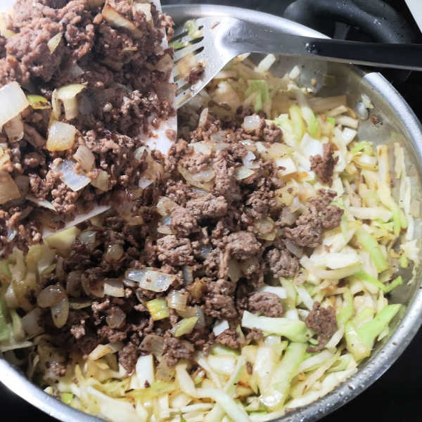 Return the meat and onions to the cabbage for this lazy cabbage roll recipe. Return the meat and onions to the cabbage for this lazy cabbage roll recipe.