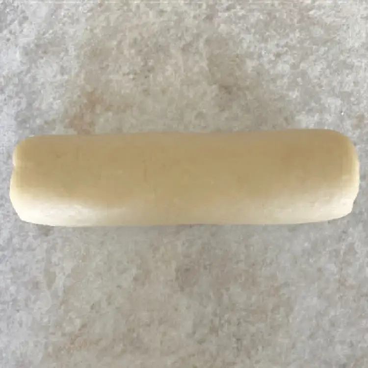 Smooth homemade German marzipan shaped into a log