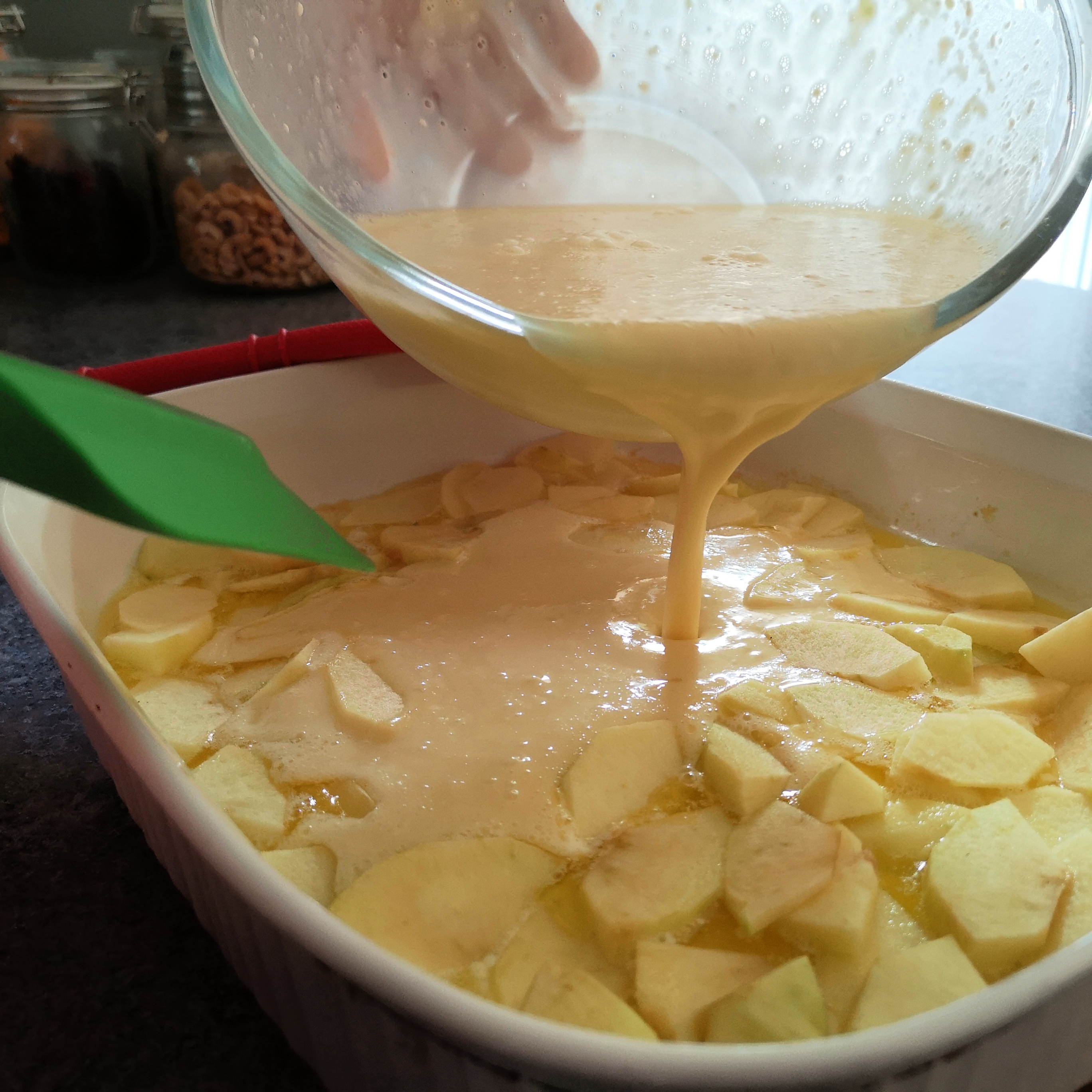 Pour the batter over the apples 