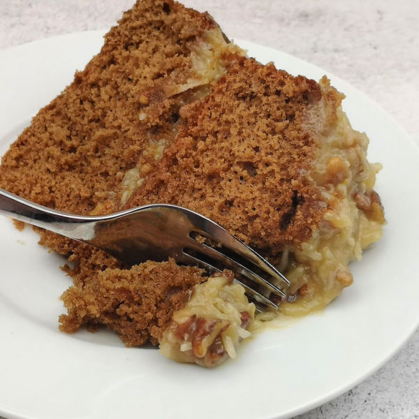 Piece of Naked German Chocolate Cake with coconut pecan frosting