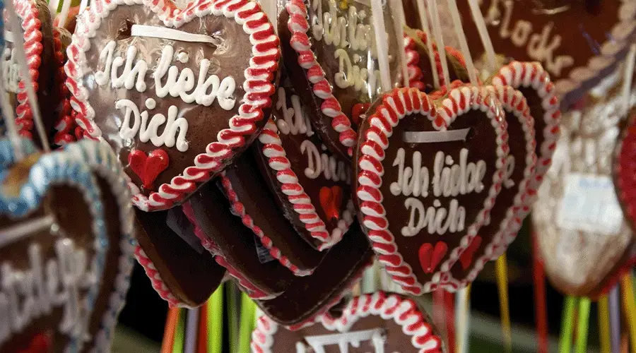 Gingerbread hearts Heart-shaped gingerbread cookies with "Ich liebe Dich" written on them, decorated with icing and displayed with colorful ribbons.