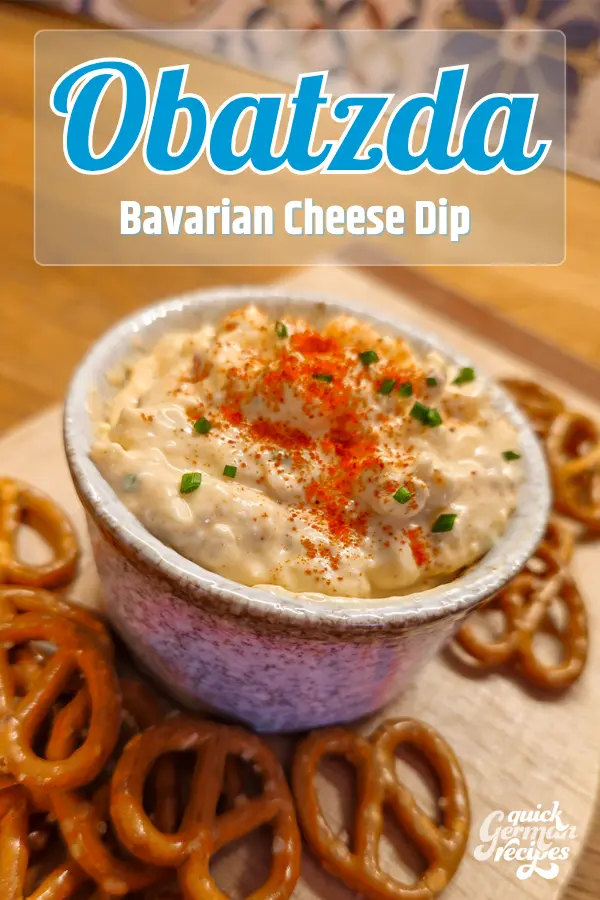 Bowl of Obatzda Bavarian cheese dip garnished with paprika and chives, served with pretzels.