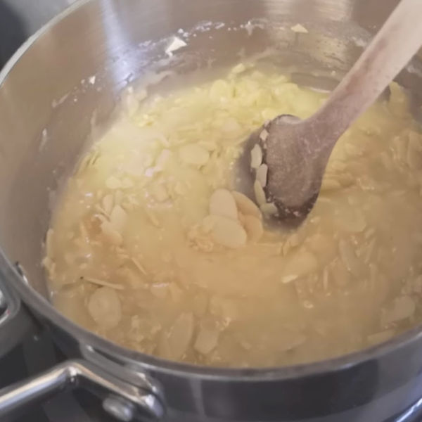 Adding nuts to the butter mixture for almond bars.
