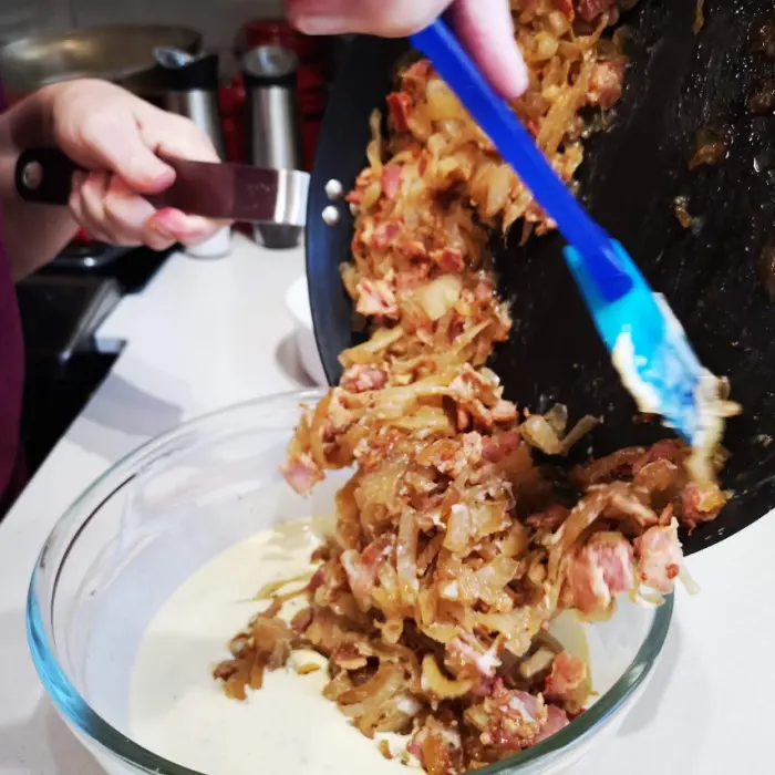 adding onion and bacon mixture to custard filling adding onion and bacon mixture to custard filling
