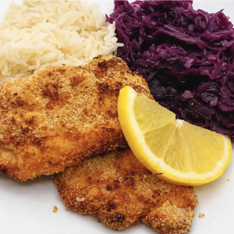 Air fryer pork schnitzel served with red cabbage and rice
