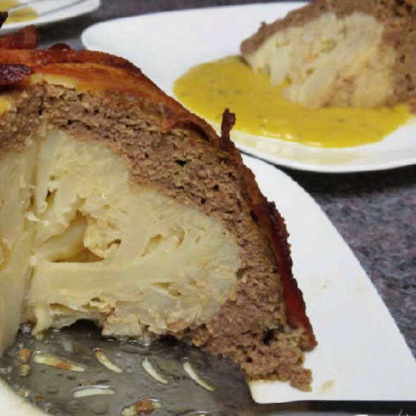 Baked Cauliflower Bomb ~ Blumenkohl-Bombe Baked Cauliflower Bomb has a whole cauliflower in the middle and is surrounded with a meatloaf mixture and topped off with bacon.