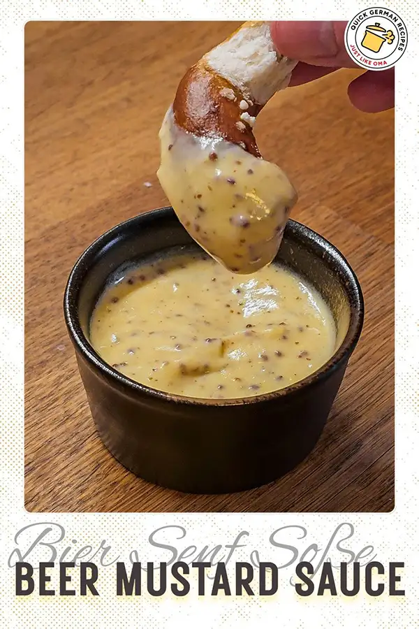 Close-up of a pretzel being dipped into creamy beer mustard sauce in a black ramekin, overlaid with the text “Beer Mustard Sauce – Bier Senf Soße.”