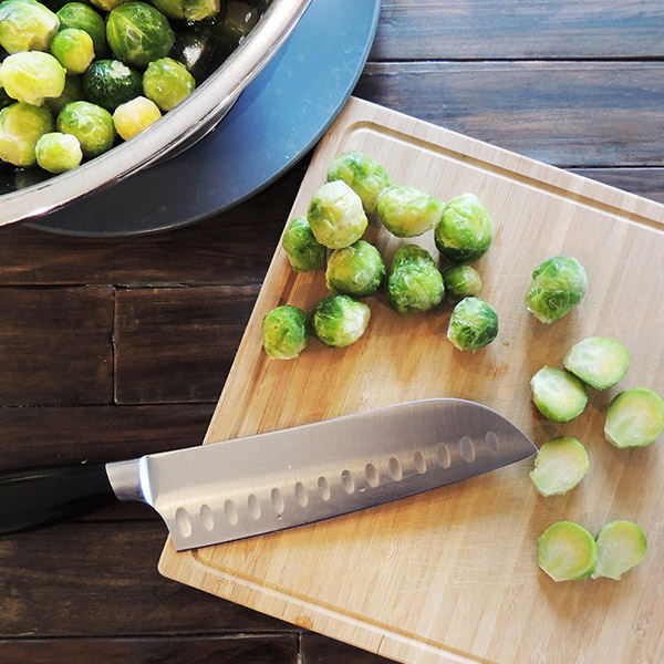 Cutting slightly thawed Brussels sprouts.