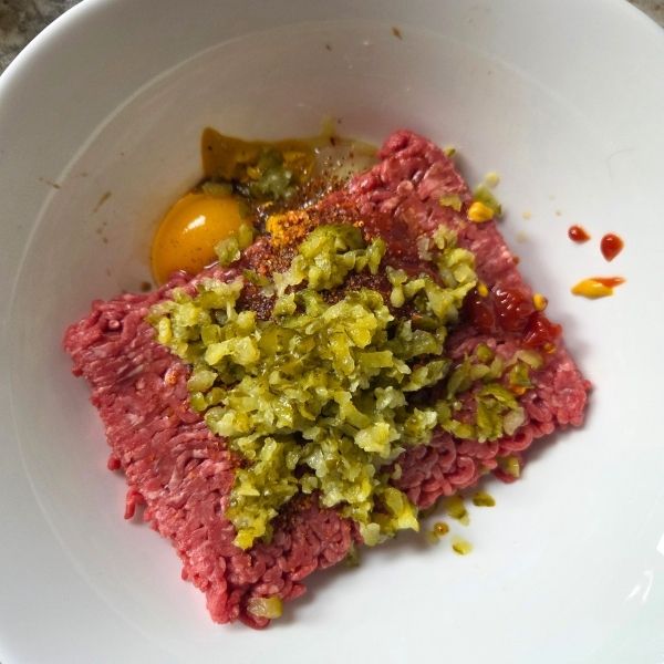 Add pickle burger ingredients into a bowl