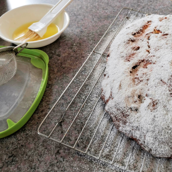 Brush with butter and sprinkle powdered sugar over stollen Brush with butter and sprinkle powdered sugar over stollen