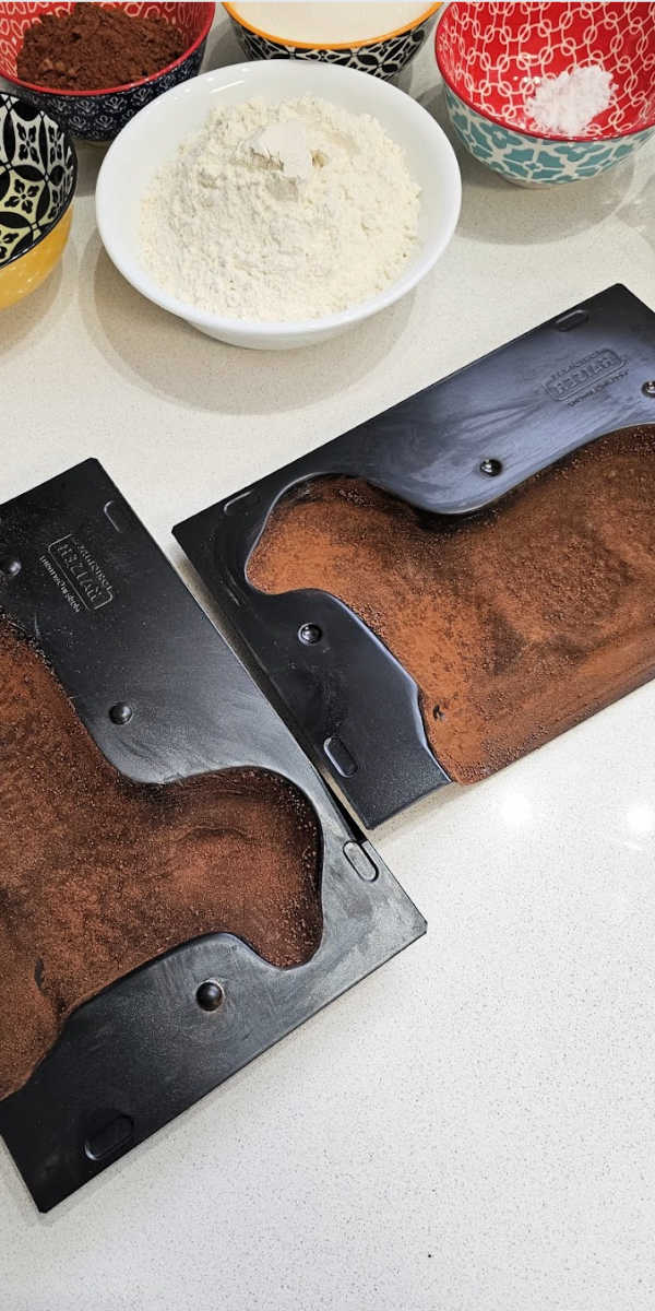 dusting cake forms with cocoa dusting cake forms with cocoa