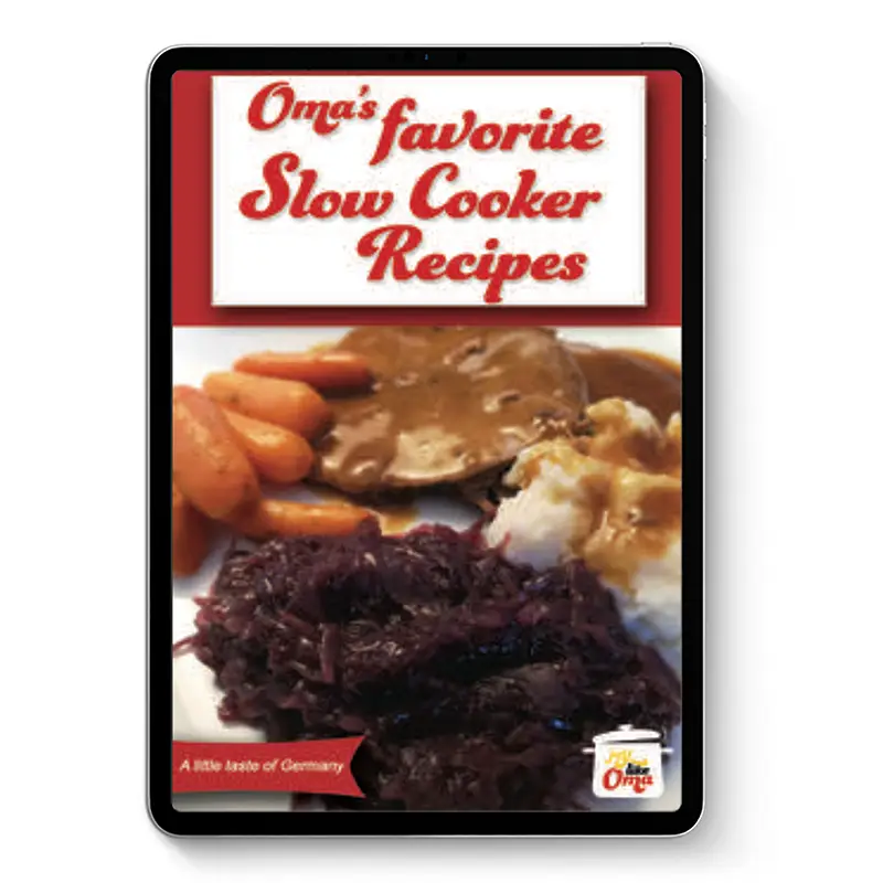 Oma’s favorite Slow Cooker Recipes ebook cover on tablet with gravy, red cabbage, carrots, and mashed potatoes.