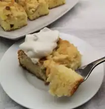 Crumb Cake Slice of German crumb cake topped with whipped cream.