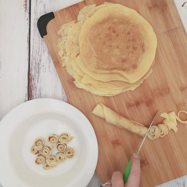 How to cut the pancakes ready to make Flädlesuppe, a German pancake soup recipe. How to cut the pancakes ready to make Flädlesuppe, a German pancake soup recipe.