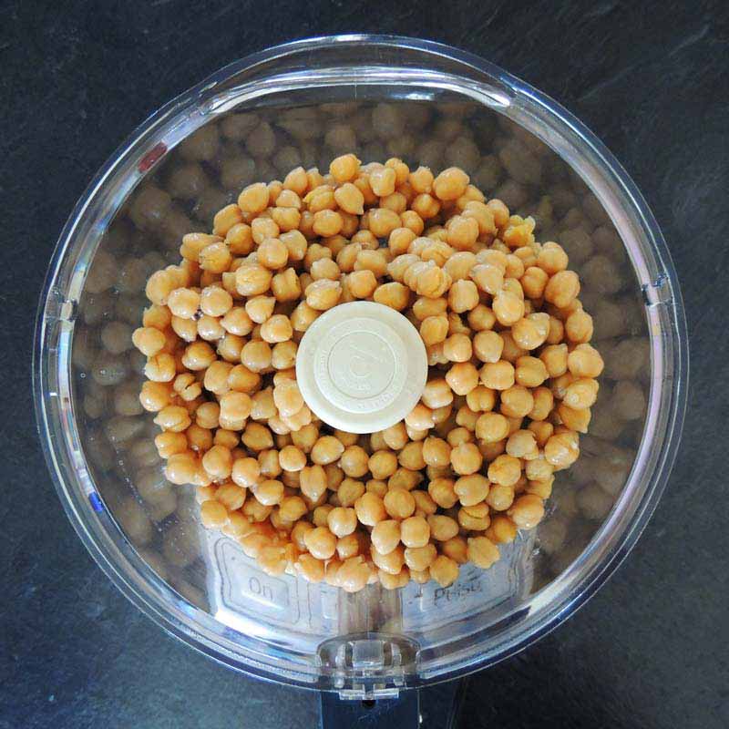 Start by adding in the chickpeas and a little bit of aquafaba ...