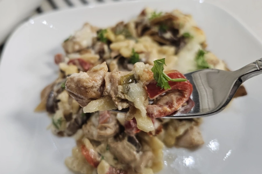 Forkful of chicken spätzle casserole with tender rotisserie chicken, red pepper and spätzle