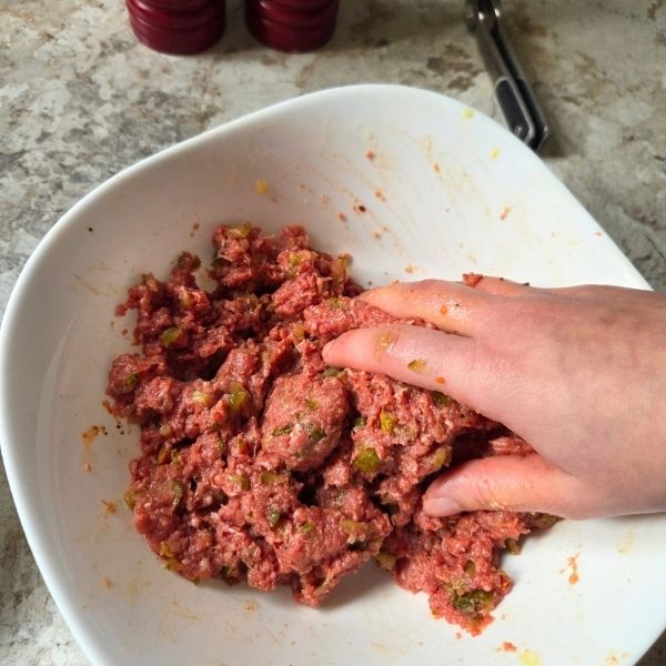 Hand-mixing ground beef mixture for burgers