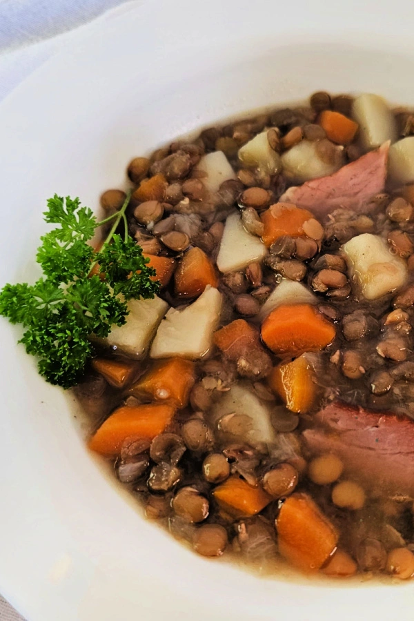 lentil soup with ham in a white bowl