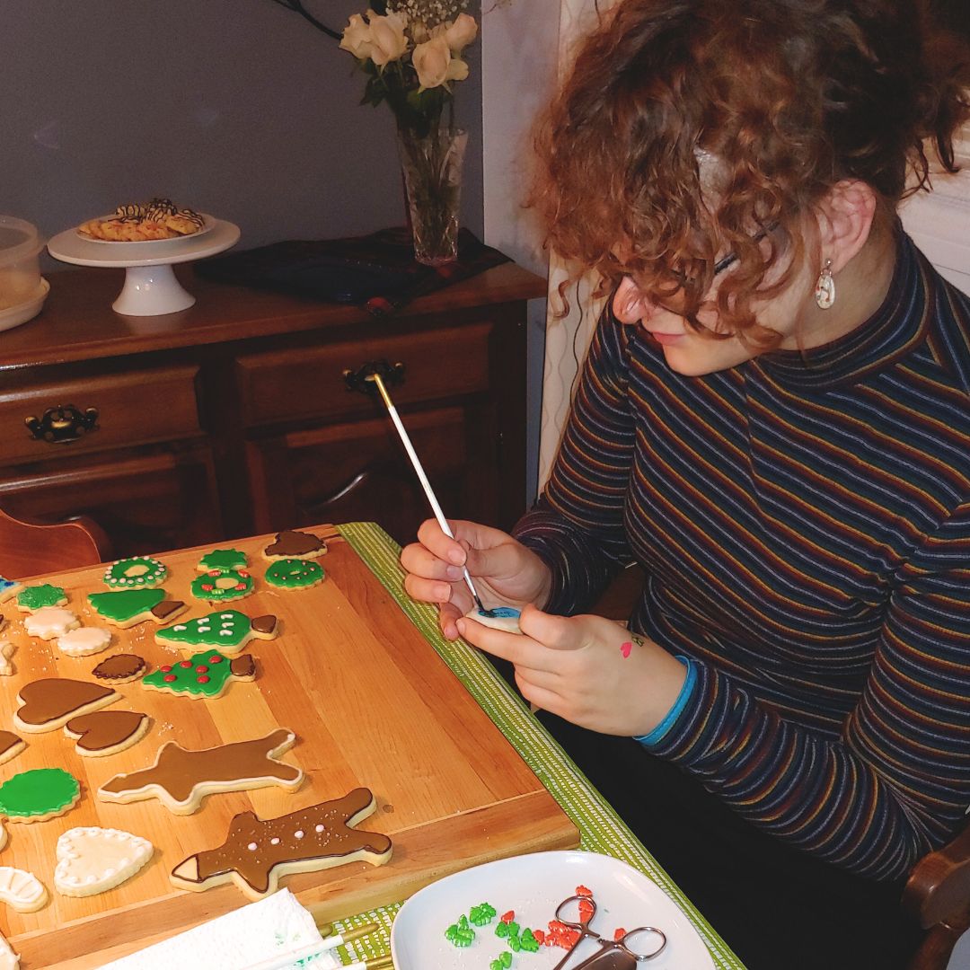 Lydia decorating the cookies using the 'painting with gel food coloring' technique. Lydia decorating and painting cookies