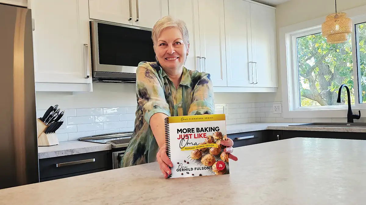 Oma Gerhild holding the new More Baking Just Like Oma Keepsake Journal Cookbook
