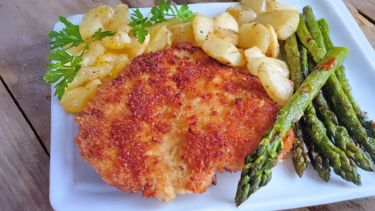 German schnitzel recipe served with roasted asparagus