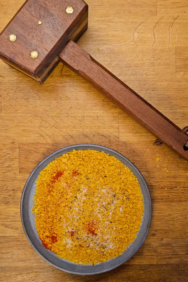 Prepping the dredging station Seasoned breadcrumb mixture for coating pork schnitzel used in schnitzel sliders.