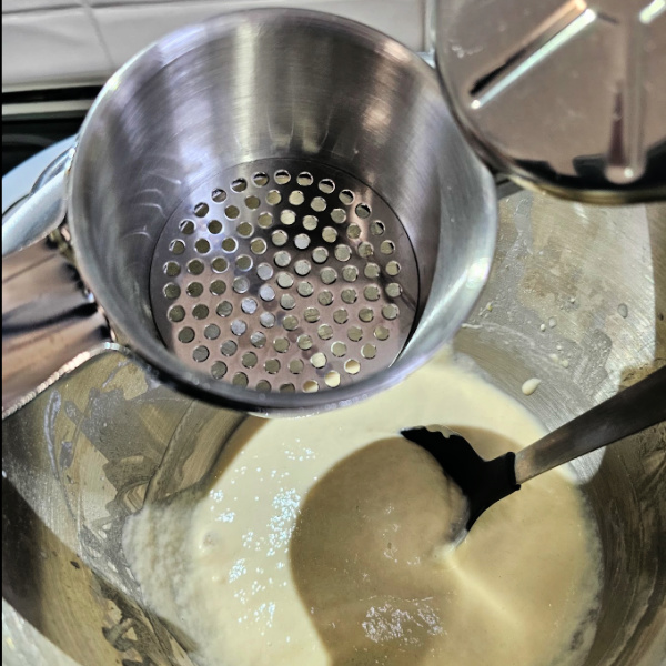 Use a Spätzle maker, sort of like a food ricer with bigger holes. Use a Spätzle maker, sort of like a food ricer with bigger holes.
