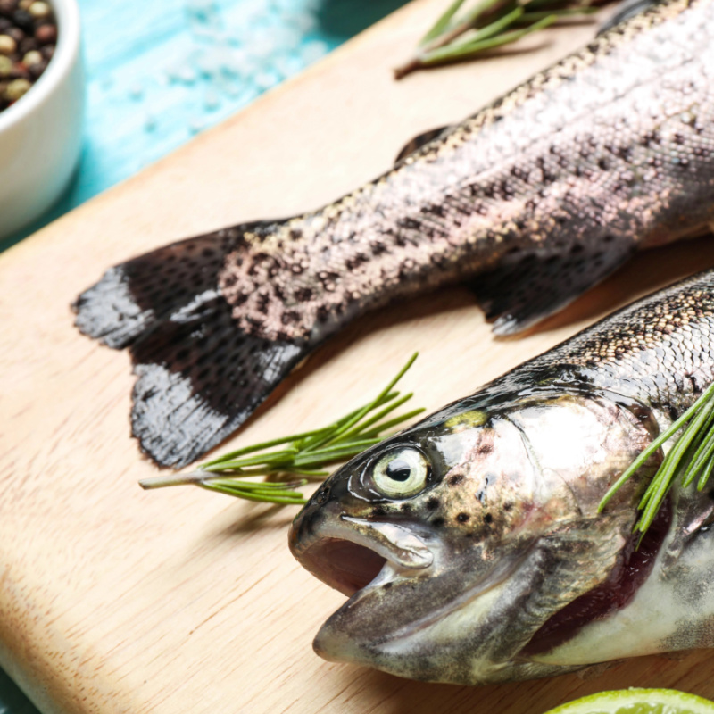 raw trout on a cutting board